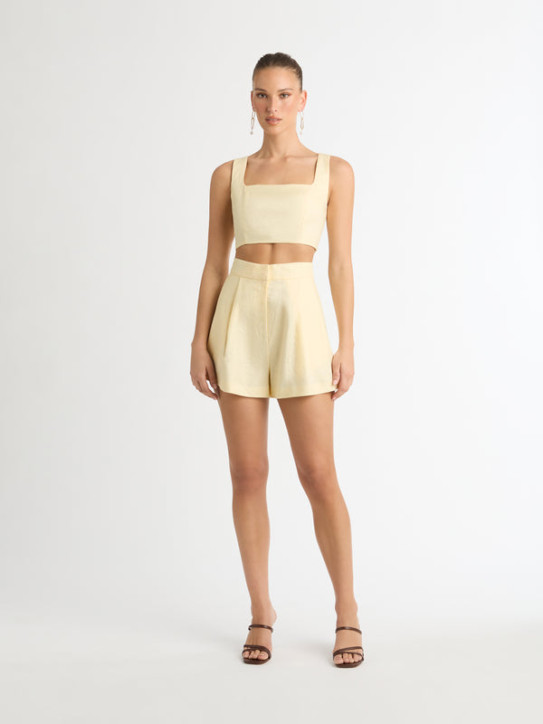 LEXI LINEN CROP TOP IN BUTTER FRONT SHOT IN SHORTS