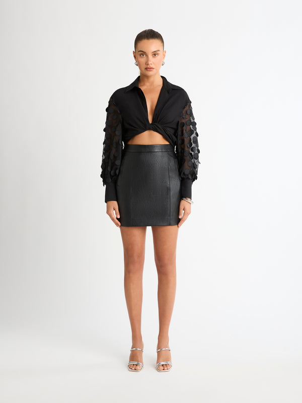 RIVAL FAUX LEATHER MINI SKIRT IN BLACK FRONT SHOT